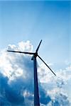 Wind turbine silhouette against dramatic sky - ecology concept