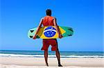 Kite surfer with the brazilian flag painted on the board with "praia e vento" (beach and wind) instead of "ordem e progresso"  in prainha beach near fortaleza