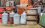 Oil barrels and gas pump in a junk yard