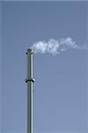 Smokestack in front of gray background. Vertical.