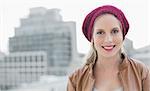 Cheerful casual blonde posing outdoors on urban background