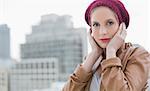 Peaceful casual blonde posing outdoors on urban background