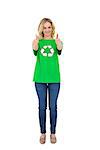 Smiling blonde environmental activist giving thumbs up to camera on white background