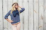 Day dreaming trendy model posing on wooden background