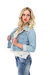 Pensive casual blonde wearing denim clothes posing on white background