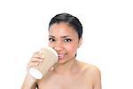 Cute young dark haired model drinking coffee on white background