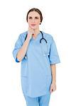 Thinking woman doctor wearing a stethoscope