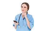 Young woman doctor thinking while holding her smartphone