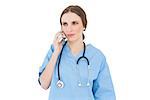 Woman doctor phoning with her smartphone while looking seriously