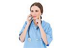 Thinking woman doctor phoning with her smartphone while lifting one hand