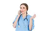Young woman doctor phoning and making a certain gesture