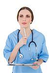 Thinking female doctor holding a clipboard on white background