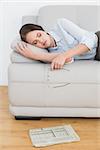 Well dressed young woman sleeping on sofa at home