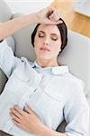 High angle view of a well dressed young woman resting on sofa at home