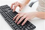 Close up midsection of a businesswoman typing on keyboard in an office