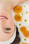 Overhead portrait of a beautiful young woman with flowers in beauty salon