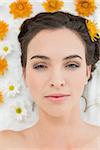 Close up portrait of a beautiful young woman with flowers in beauty salon