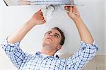 Close up of a young plumber repairing washbasin drain in bathroom