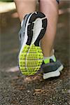 Woman running away from camera close up in trainers