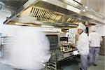 Team of chefs working in a kitchen at a hurried pace