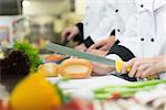 Close up of chef slicing bread roll in a kitchen