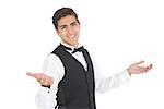 Handsome young waiter making a certain gesture smiling at camera