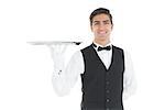 Attractive waiter presenting an empty tray smiling at camera