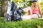 Casual attractive blonde wearing roller blades in a park