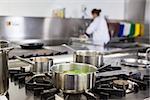 Different pots cooking on hotplate in professional kitchen