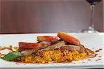 Front view of couscous dish with meat on wooden table