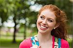 Gorgeous cheerful student looking up on campus at college