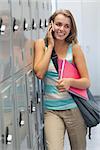 Smiling pretty student phoning in school