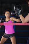 Female boxer focused on her training in the boxing ring