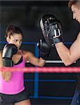 Determined female boxer focused on her training in the boxing ring