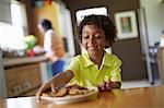 Boy looking at plate of cookies