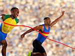 Two athletes reaching finishing line