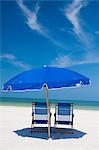 Deckchairs and parasol on beach, Clearwater, Florida, United States