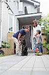 Father with dog talking to son