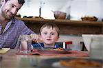 Father with son eating dinner