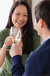 Mature couple toasting with white wine
