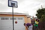 Two brothers playing basketball