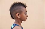 Portrait of boy with mohawk hairstyle, side view