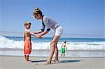 Mother and sons on beach