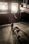 Two young adults working out in gym