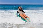 Young woman surfing, Hermosa Beach, California, USA