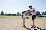 Grandfather and grandson on baseball field