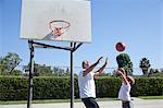 Man and grandson playing basketball