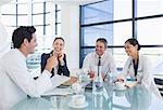 Doctors and business people talking in meeting