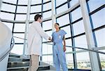 Doctor and nurse handshaking on hospital staircase