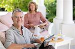 Senior man using laptop on patio